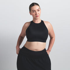 NikeSKIMS SHINE HIGH NECK BRA | OBSIDIAN ON A MODEL SIDE VIEW