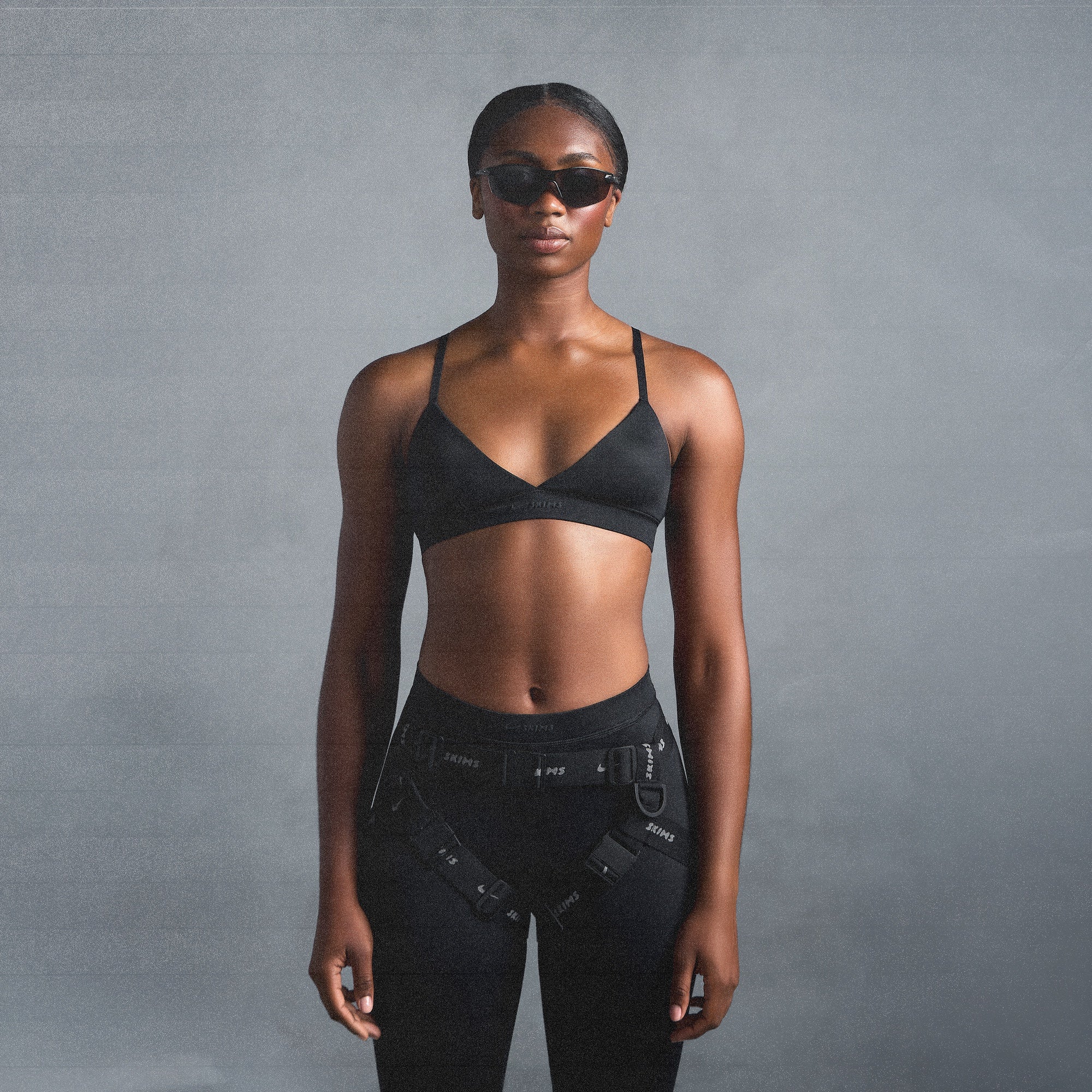 NikeSKIMS SHINE TRIANGLE BRA | OBSIDIAN ON A MODEL SIDE VIEW @ | FOCUS: 0.0, 1.0, 0.9