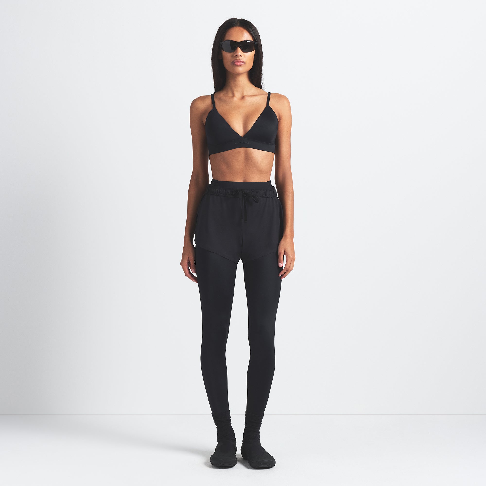NikeSKIMS SHINE TRIANGLE BRA | OBSIDIAN ON A MODEL FRONT VIEW @ | FOCUS: 0.9, 0.1, 0.7