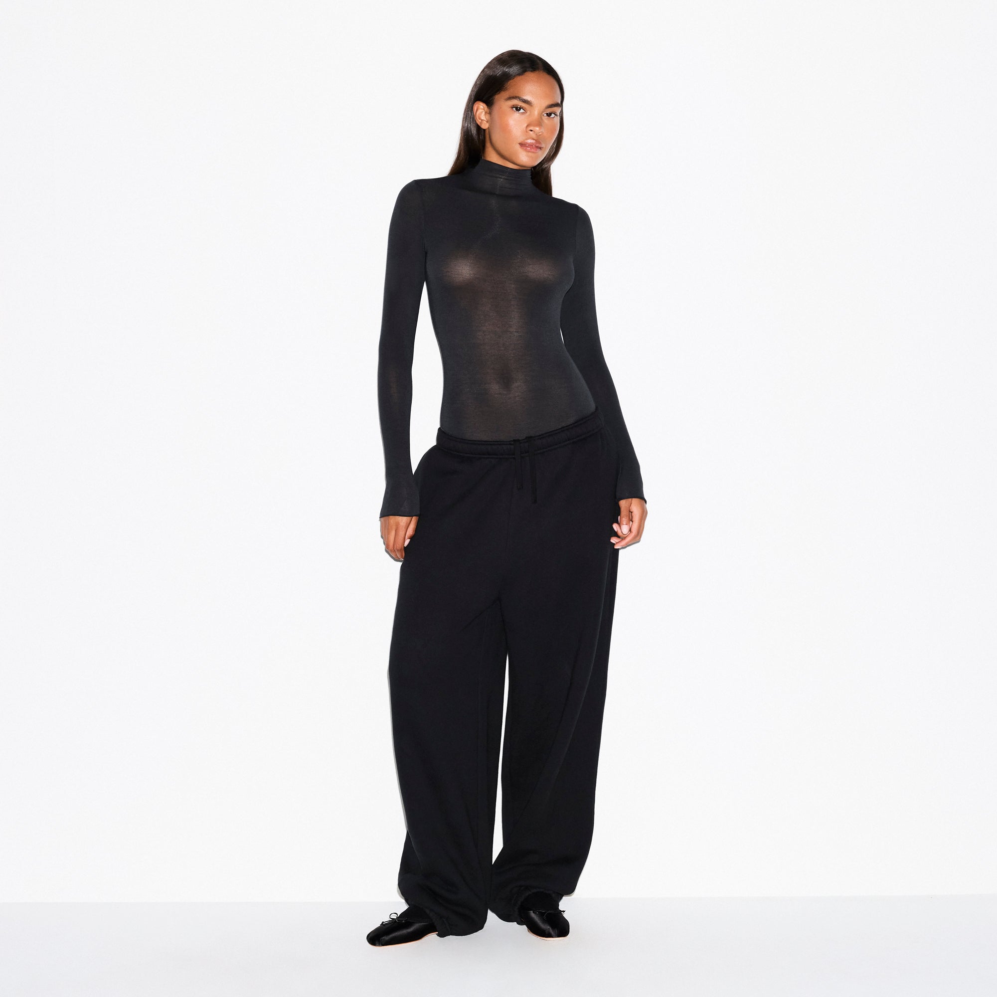 SHEER MODAL LONG SLEEVE TURTLENECK BODYSUIT | ONYX ON A MODEL FRONT VIEW @ | FOCUS: 0.0, 1.0, 0.9