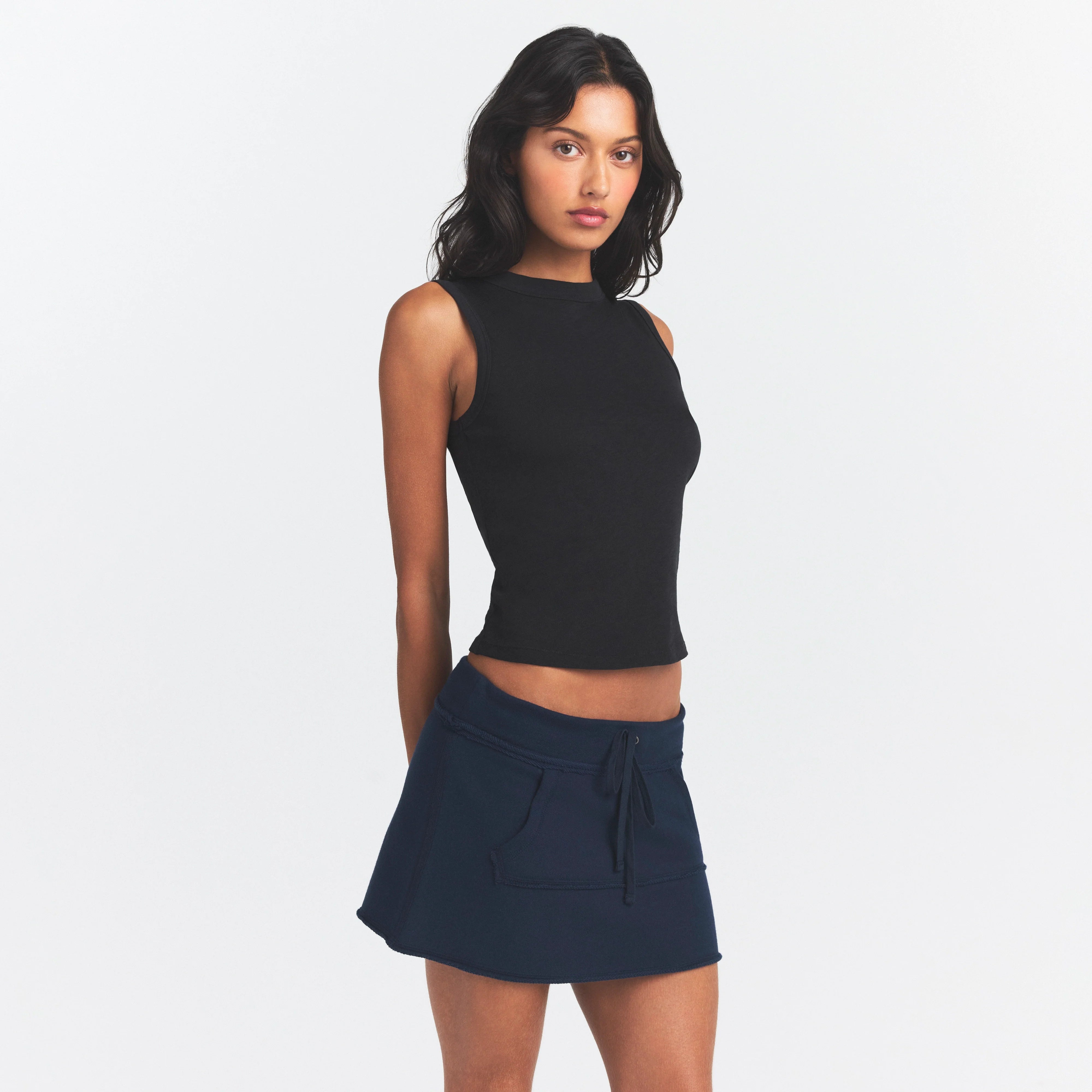 DRAPEY FRENCH TERRY MINI SKIRT | NAVY ON A MODEL SIDE VIEW @ | FOCUS: 0.0, 1.0, 0.9