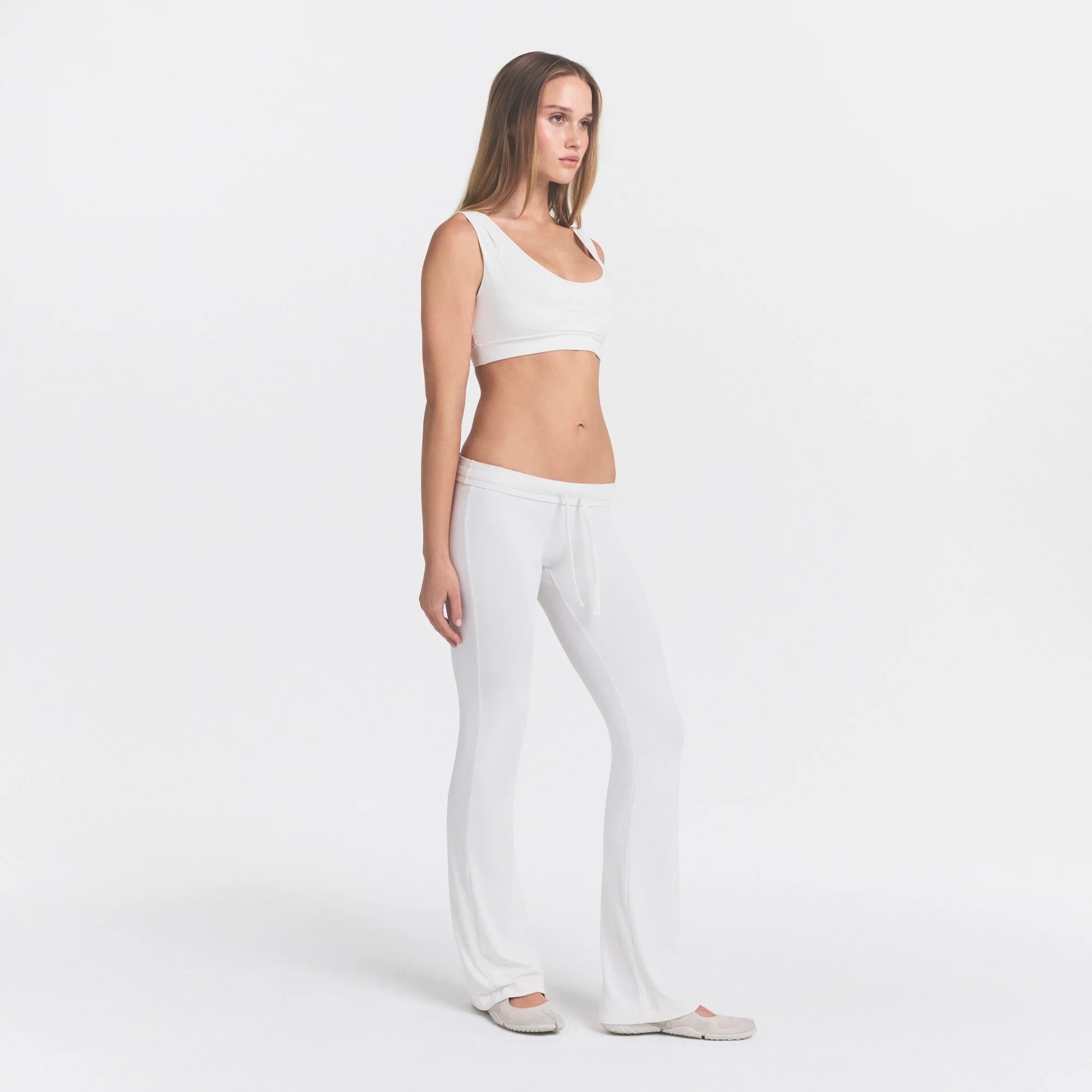 NikeSKIMS AIRY LOW RISE MINI FLARE PANT | IVORY ON A MODEL