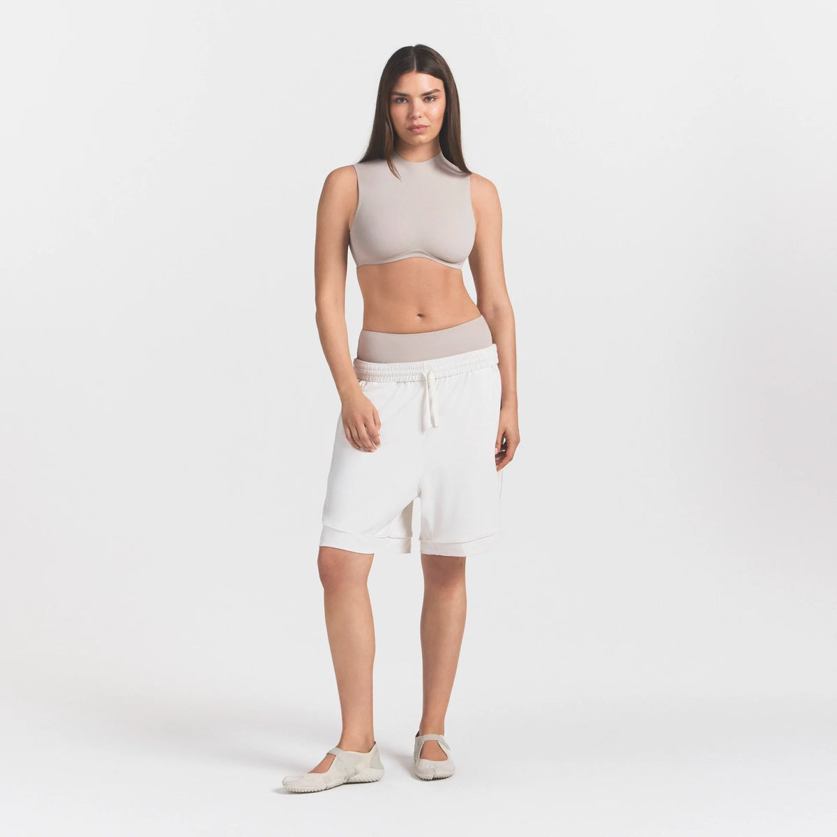 NikeSKIMS AIRY RELAXED SHORT | IVORY ON A MODEL