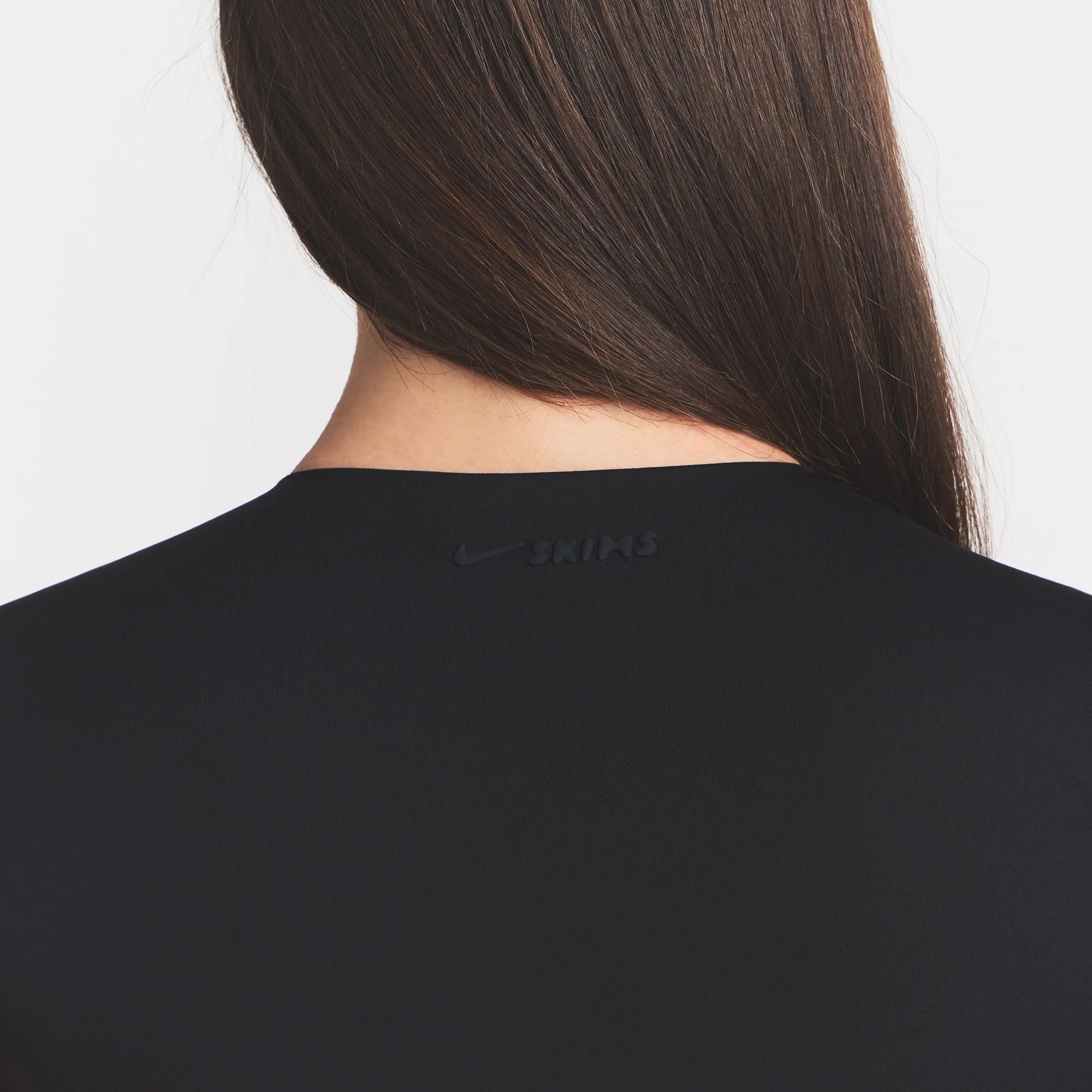 NikeSKIMS MATTE CORSET CROP TOP | OBSIDIAN ON A MODEL