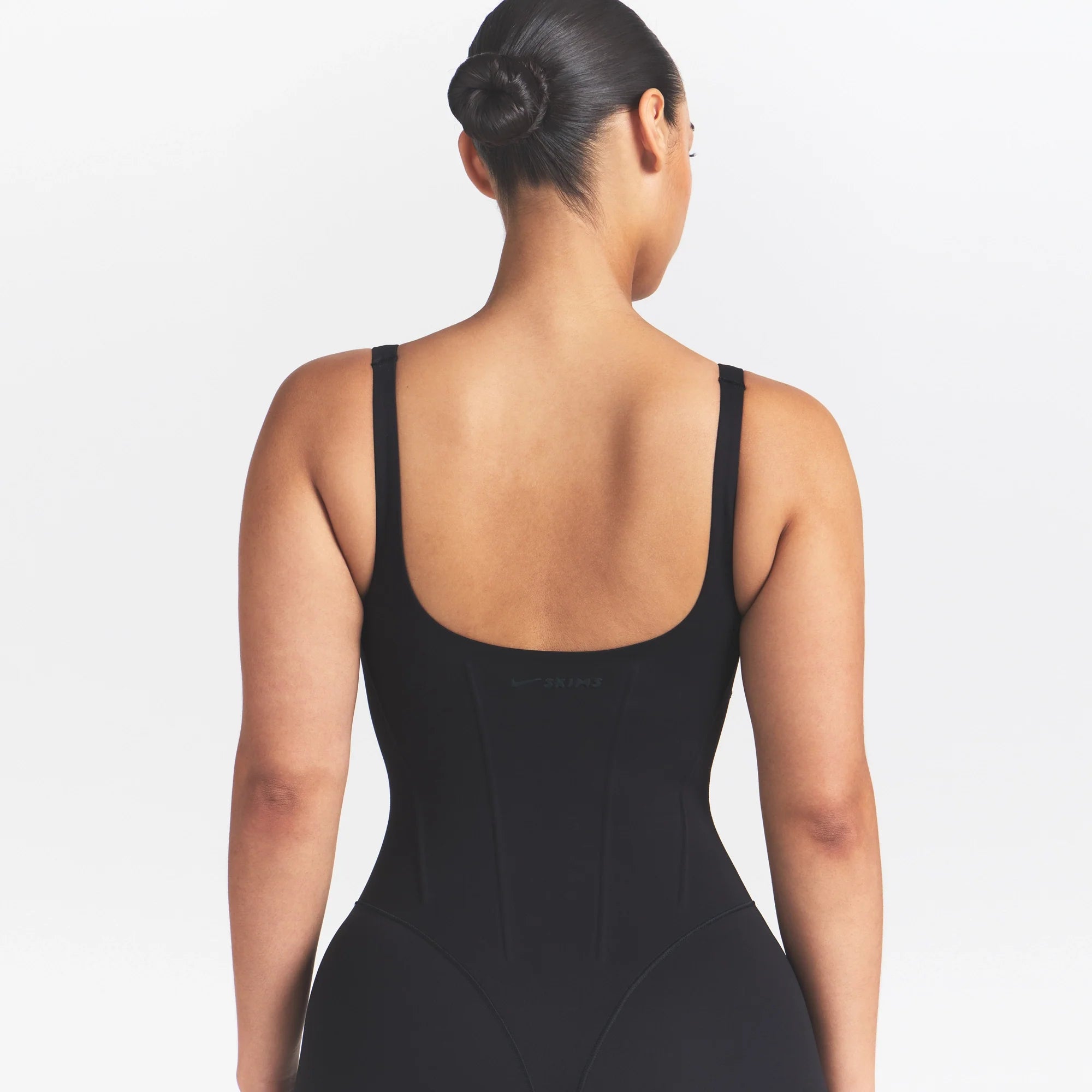 NikeSKIMS MATTE CORSET 2" ONE PIECE | OBSIDIAN ON A MODEL