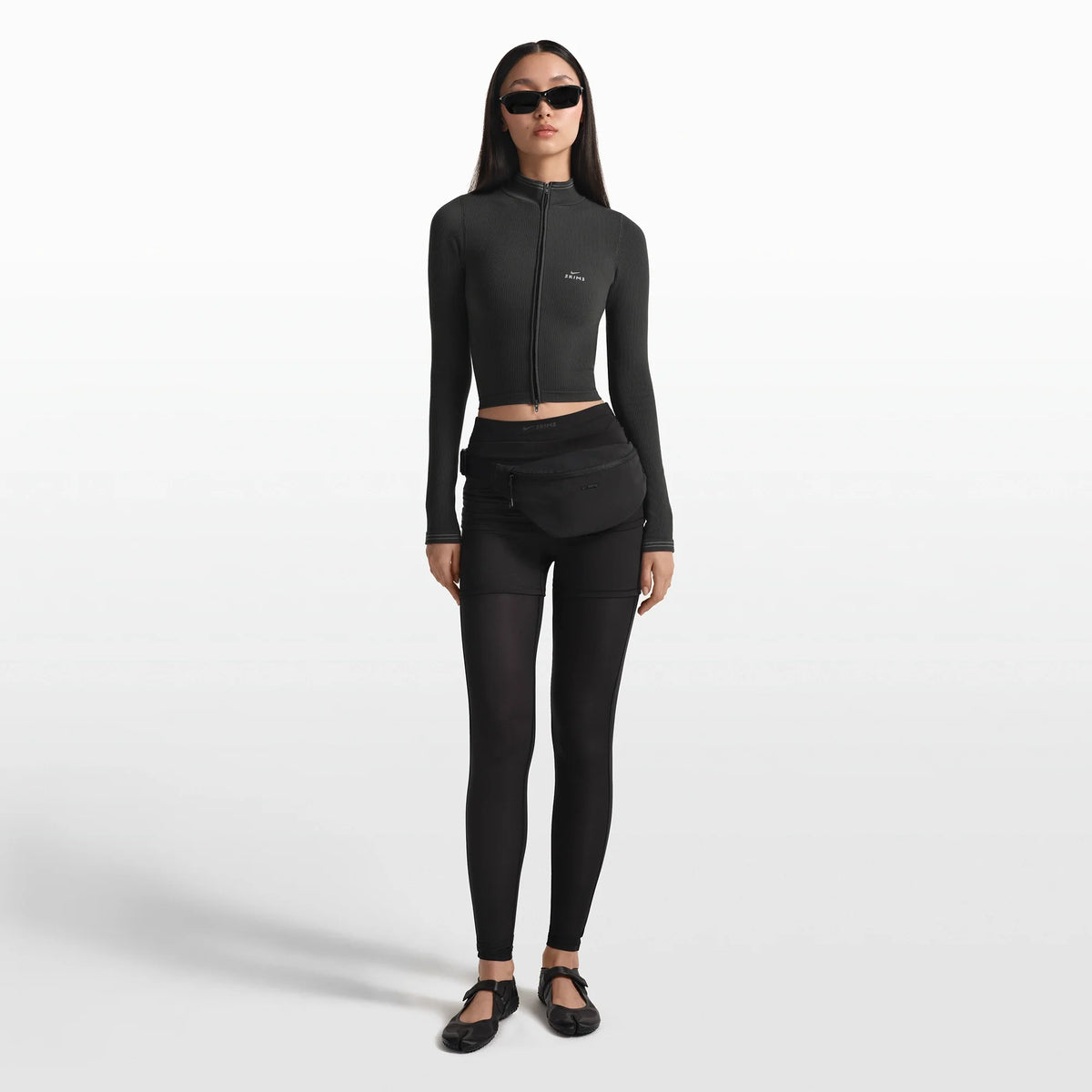 NikeSKIMS ACCESSORIES FANNY PACK | OBSIDIAN ON A MODEL FRONT VIEW @ | FOCUS: 0.0, 1.0, 0.9