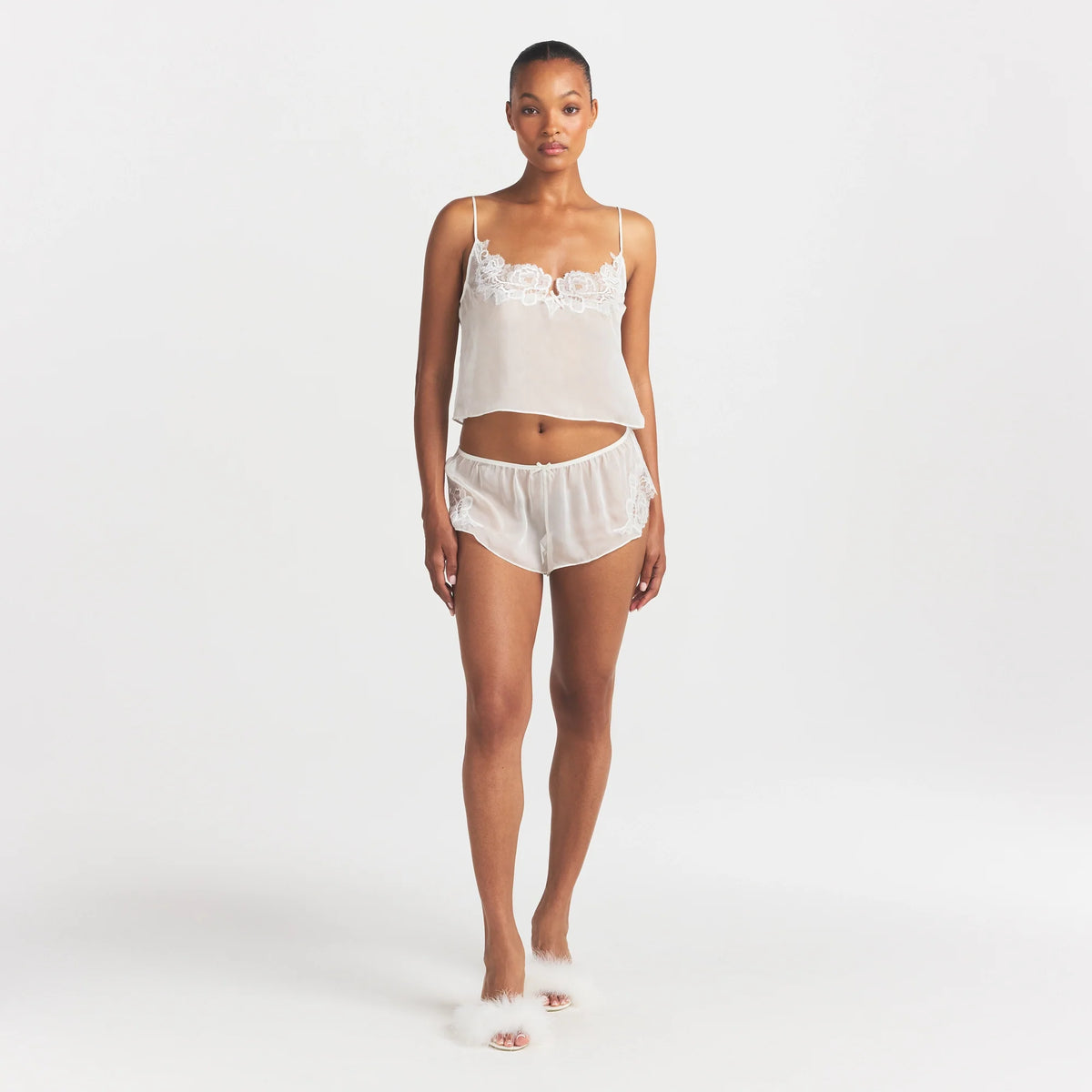 SKIMS ROMANCE CAMI AND SHORT SET | IVORY ON A MODEL FRONT VIEW @ | FOCUS: 0.0, 1.0, 0.9