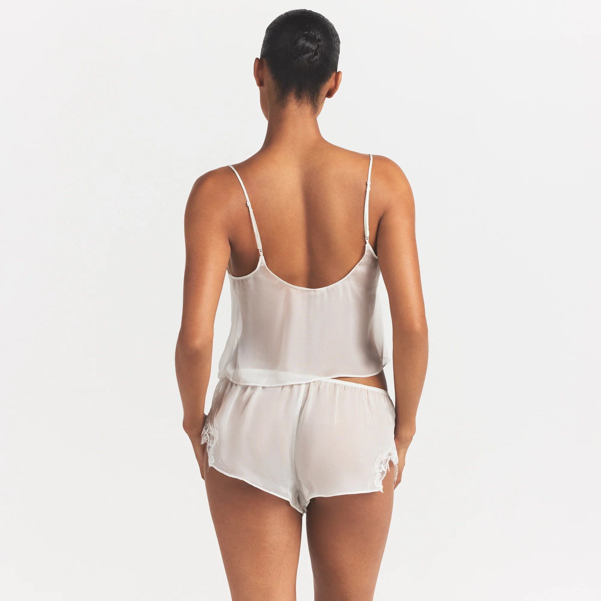 SKIMS ROMANCE CAMI AND SHORT SET | IVORY ON A MODEL SIDE VIEW @ | FOCUS: 0.0, 1.0, 0.9