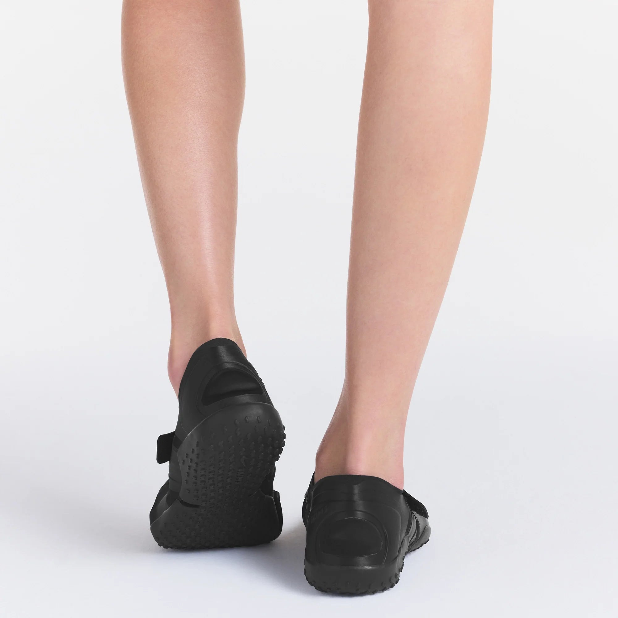NikeSKIMS FOOTWEAR RIFT SATIN | BLACK ON A MODEL BACK VIEW| FOCUS: 0.0, 1.0, 0.9