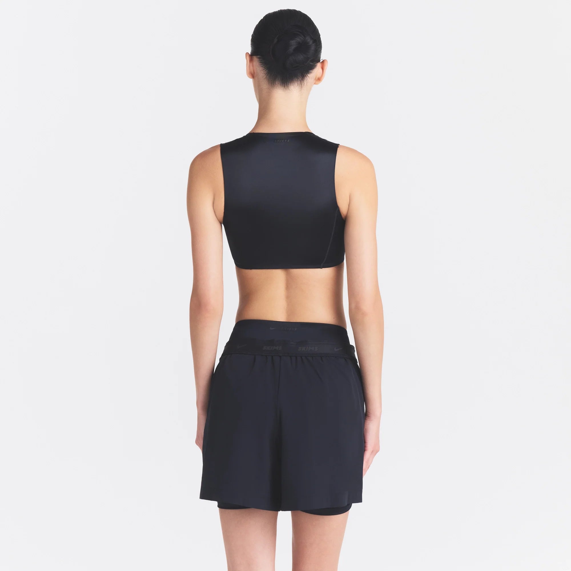 NikeSKIMS STRETCH NYLON 5" TRACK SHORT | OBSIDIAN ON A MODEL SIDE VIEW