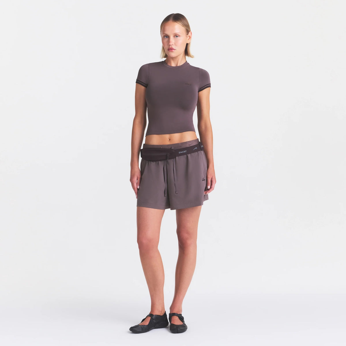 NikeSKIMS STRETCH NYLON 5" TRACK SHORT | RESIN ON A MODEL FRONT VIEW