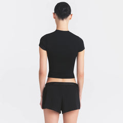 NikeSKIMS STRETCH KNIT CROPPED T-SHIRT | OBSIDIAN ON A MODEL SIDE VIEW @ | FOCUS: 0.0, 1.0, 0.9