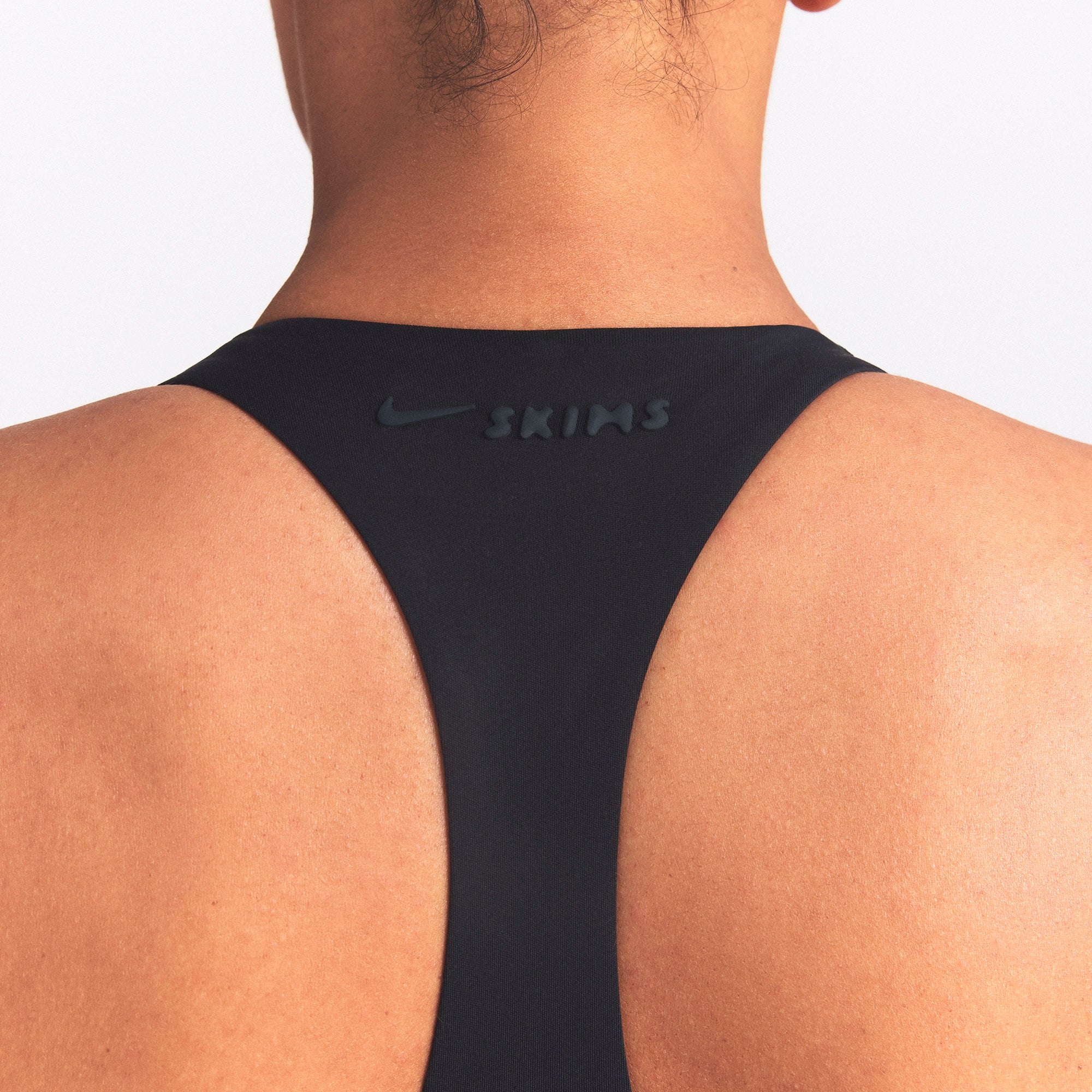 NikeSKIMS MATTE AND SHINE RACERBACK 5" ONE PIECE | OBSIDIAN/IGNEOUS ON A MODEL SIDE VIEW @ | FOCUS: 0.0, 1.0, 0.9