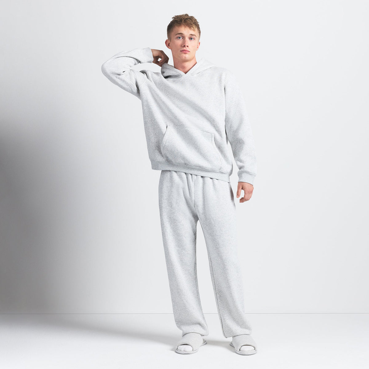 FLEECE LOUNGE MENS RELAXED HOODIE | LIGHT HEATHER GREY ON A MODEL FRONT VIEW @ | FOCUS: 0.0, 1.0, 0.9