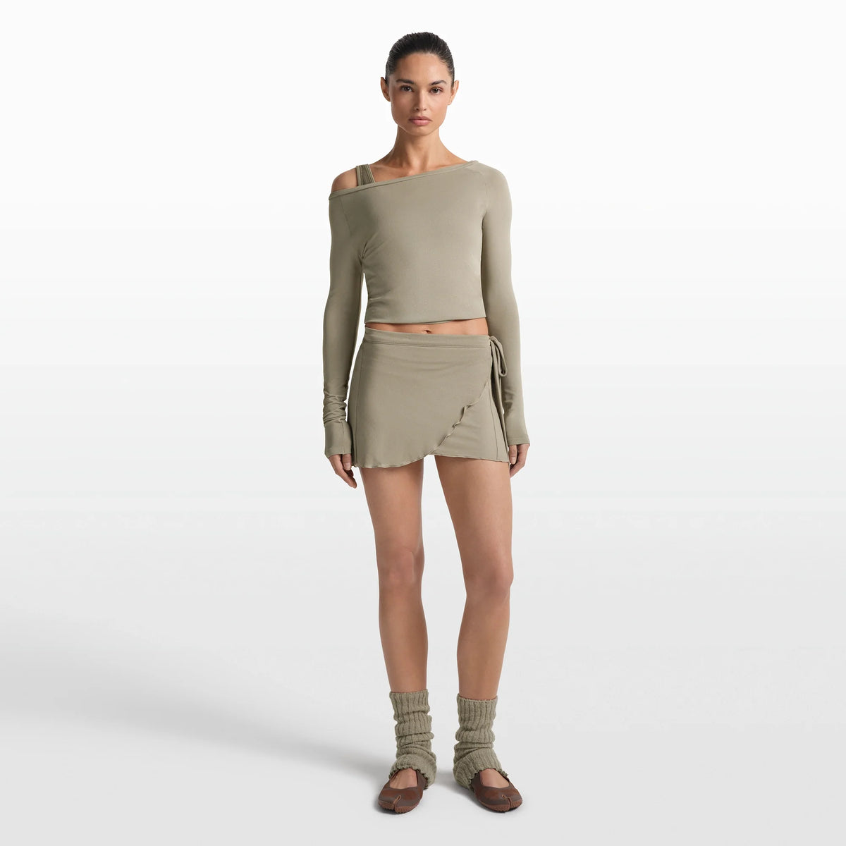 NikeSKIMS STRETCH KNIT WRAP SKIRT | DUNE ON A MODEL FRONT VIEW @ | FOCUS: 0.0, 1.0, 0.9