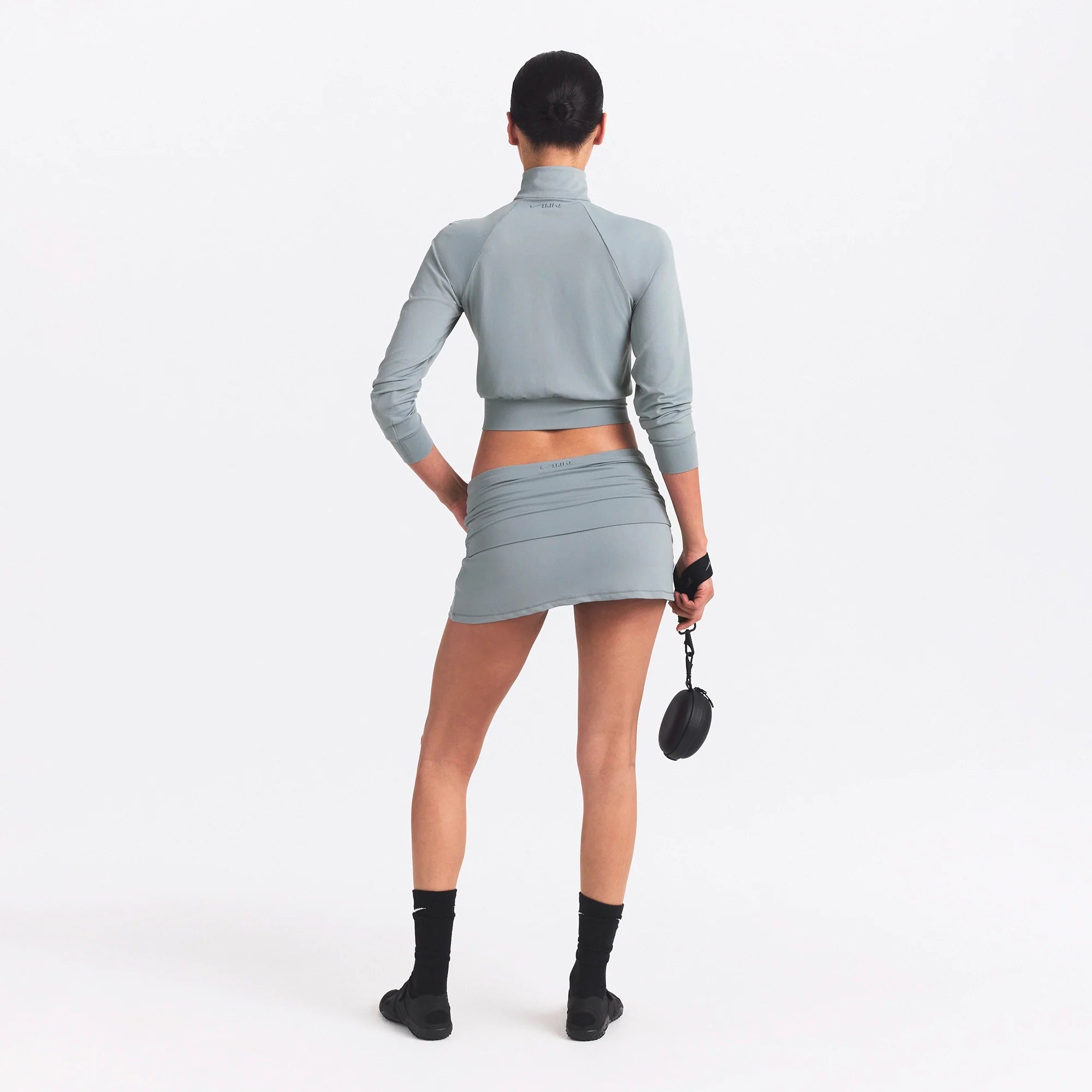 NikeSKIMS AIRY FOLDOVER SKORT | WASHED PACIFIC ON A MODEL SIDE VIEW @ | FOCUS: 0.0, 1.0, 0.9