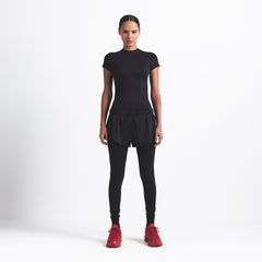 NikeSKIMS MATTE PADDED BABY TEE | OBSIDIAN ON A MODEL FRONT VIEW @ | FOCUS: 0.9, 0.1, 0.7