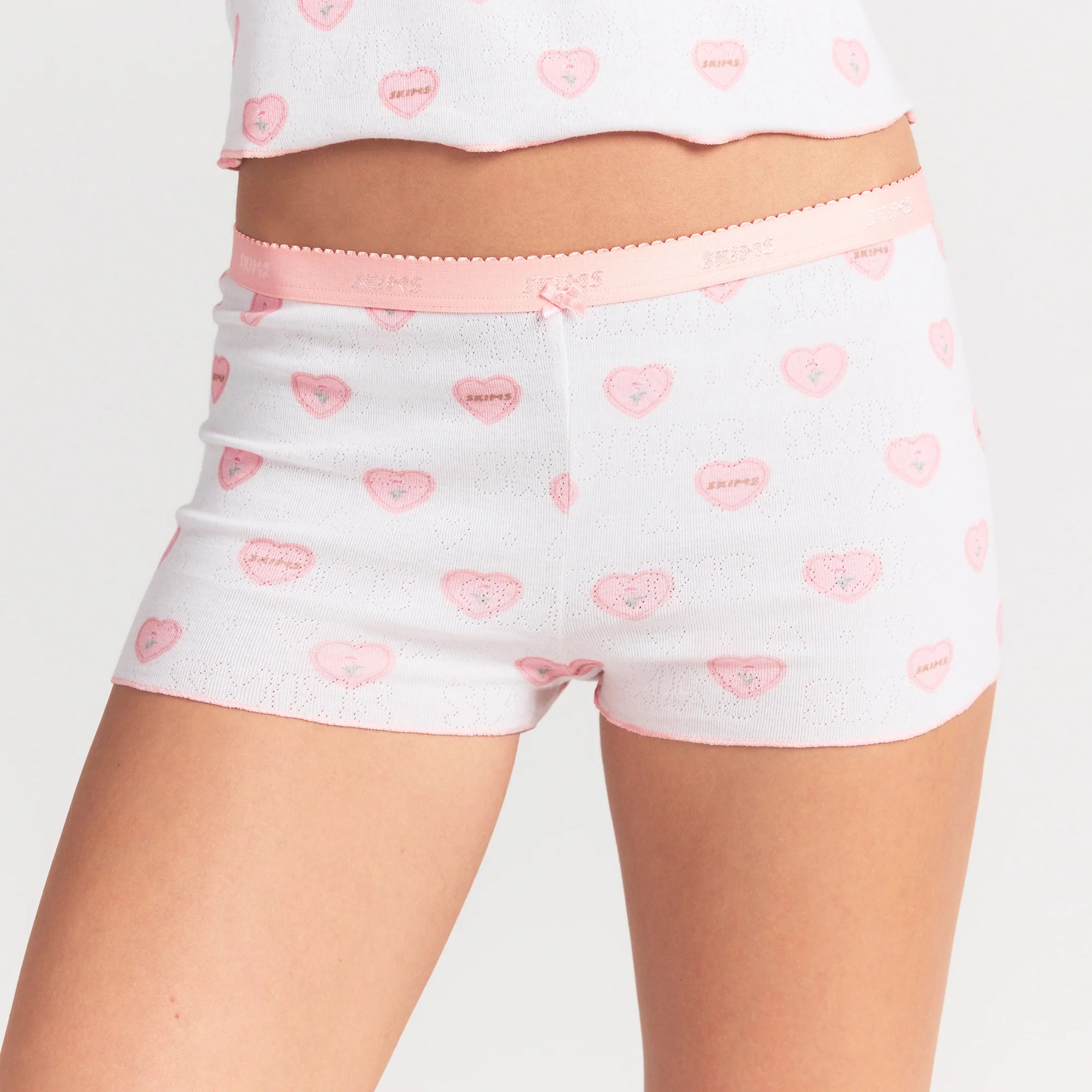 LOGO POINTELLE BABY TEE AND SHORT SET | SNOW LACE HEARTS ON A MODEL SIDE VIEW @ | FOCUS: 0.0, 1.0, 0.9