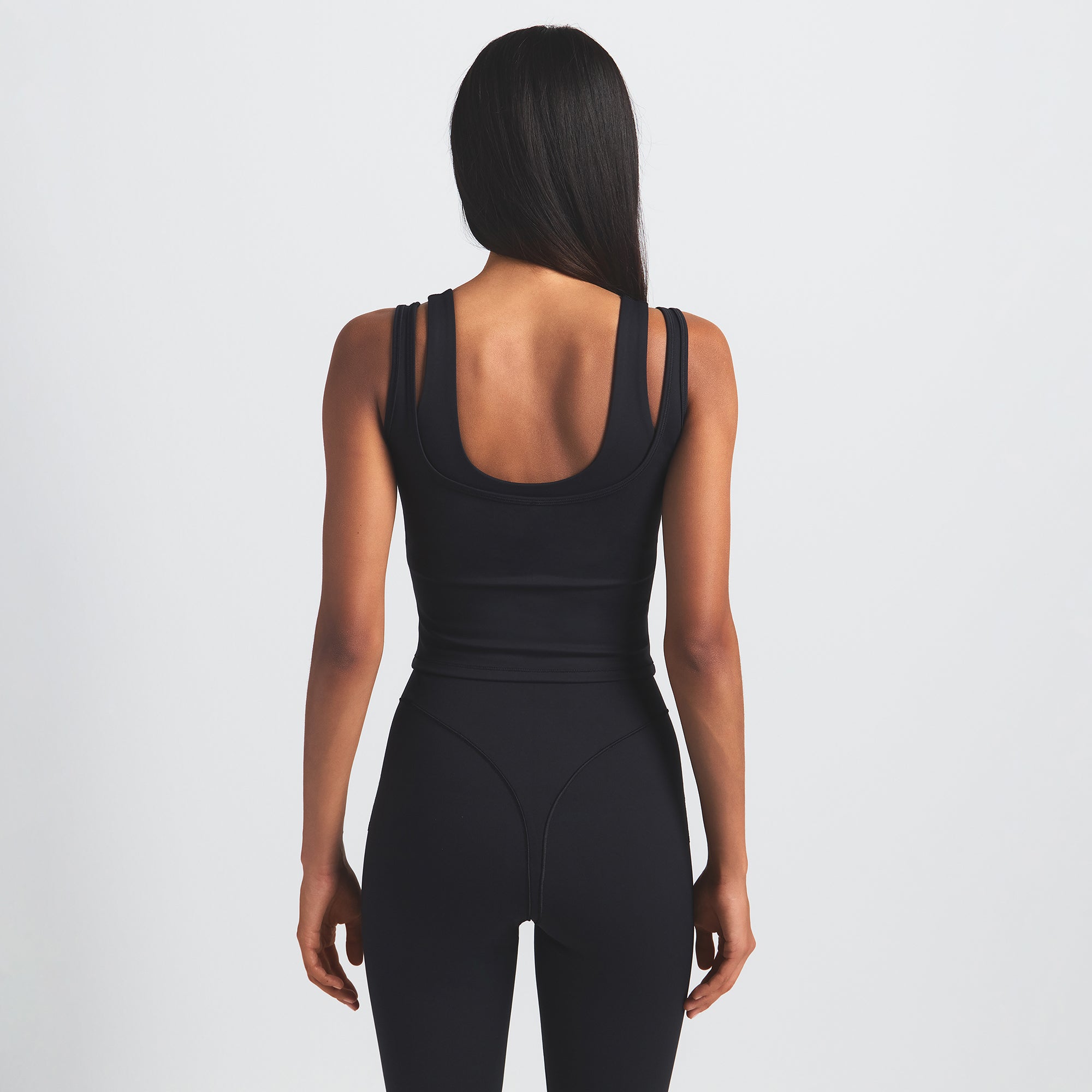 NikeSKIMS MATTE DOUBLE STRAP SCOOP TANK | OBSIDIAN ON A MODEL BACK VIEW @ | FOCUS: 0.0, 1.0, 0.9